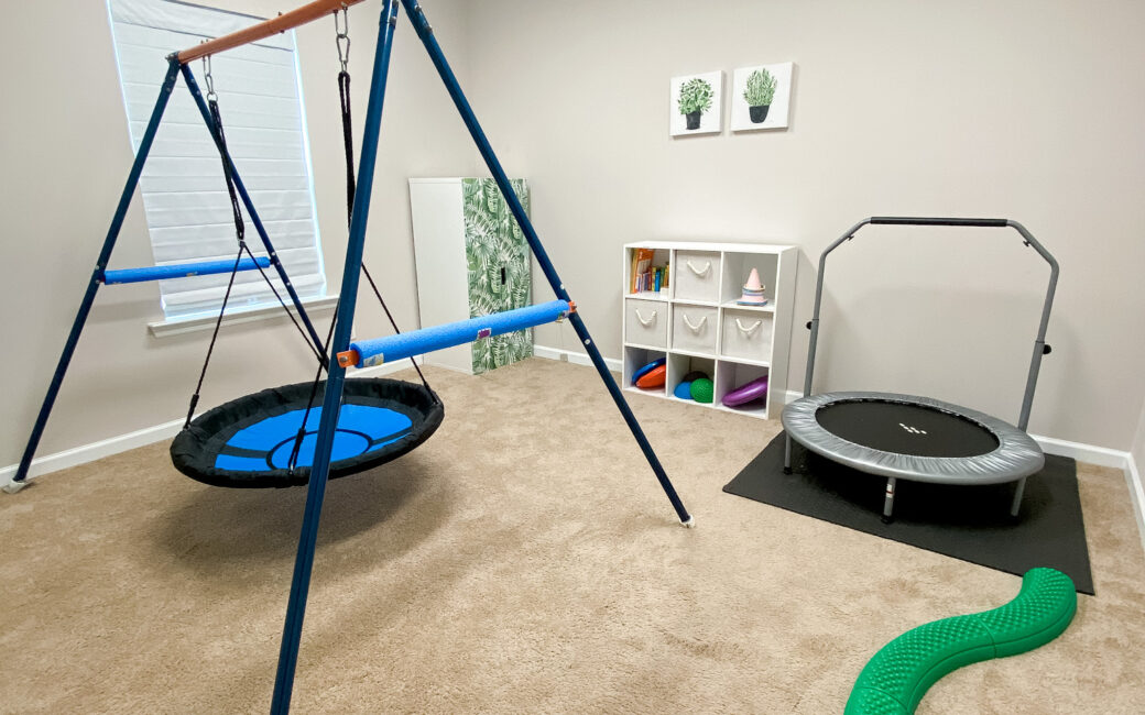 Motor room with swing, trampoline, and balance beam