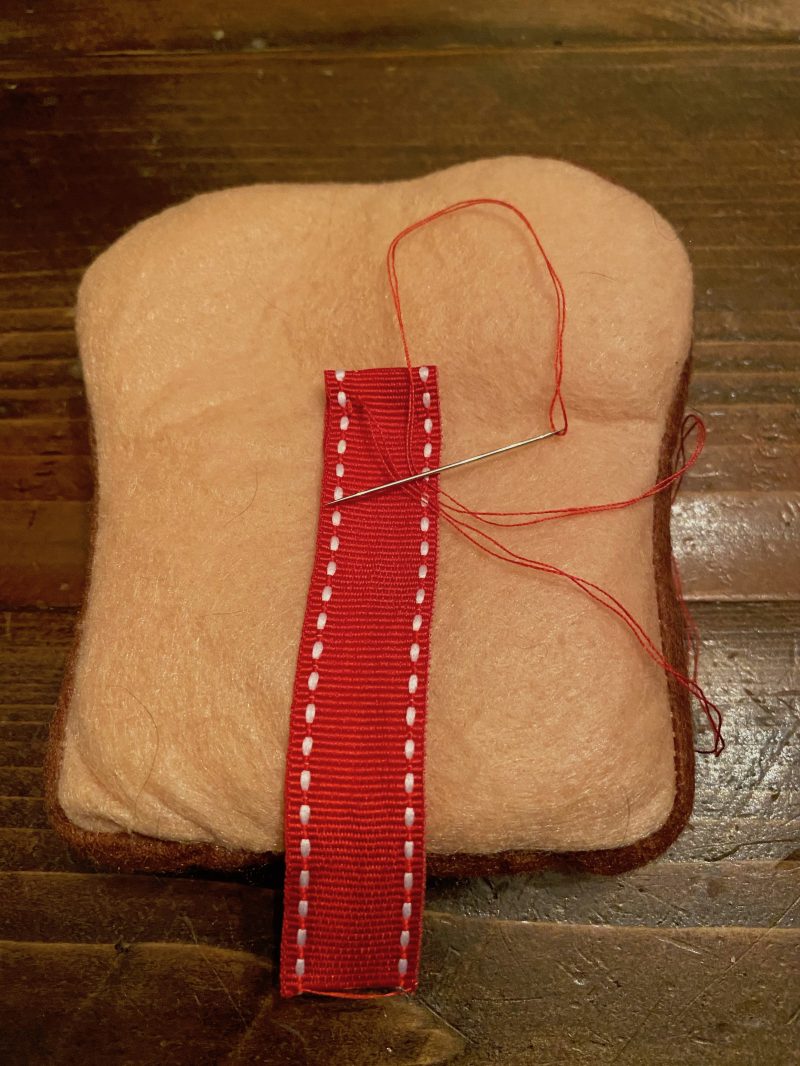 Felt sandwich bread with ribbon sewn to center